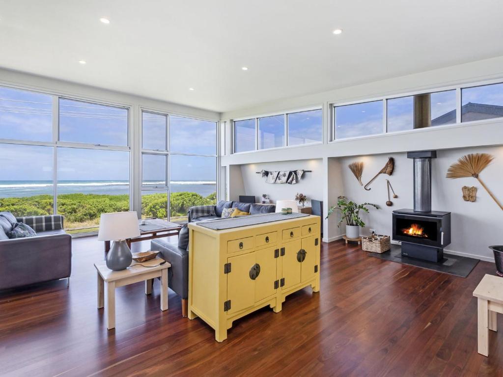 a living room with a couch and a fireplace at Sea Lit in Port Fairy