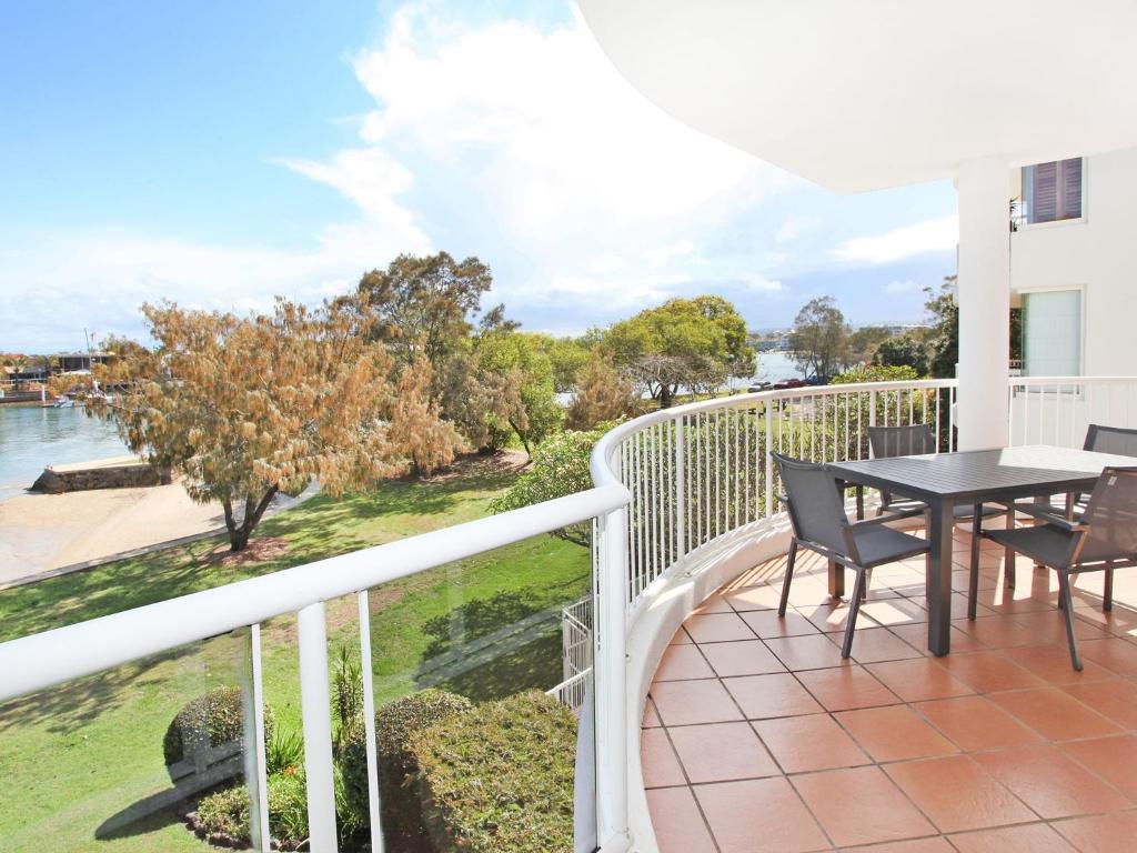 a balcony with a table and chairs and a view of the water at 2 bedroom apartment in Parkyn Parade, the best location in town! in Mooloolaba