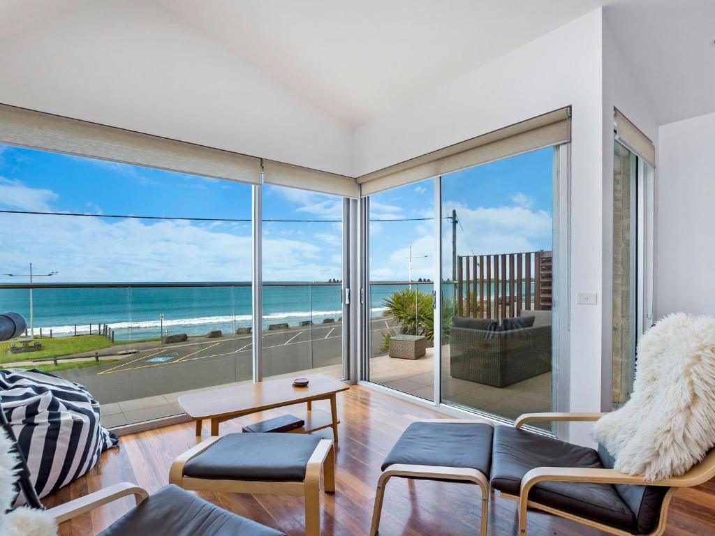 a living room with a view of the ocean at Farmers Retreat in Port Fairy