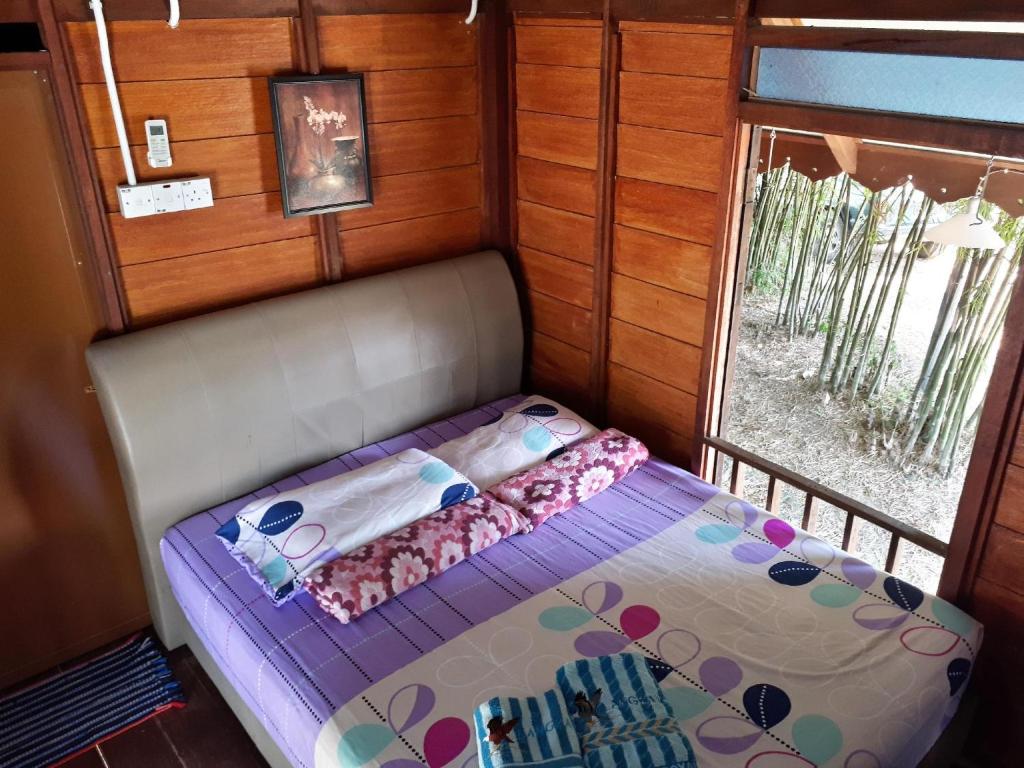 Postel nebo postele na pokoji v ubytování THE COTTAGE LANGKAWI