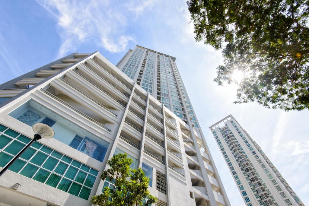 a tall building with the sky in the background at Straits Garden Suites by The Homestay Helper in George Town