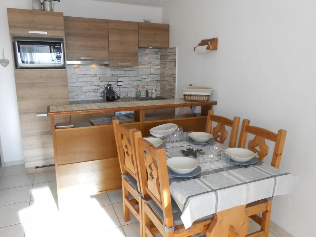 a dining room with a table and chairs and a kitchen at Appartement Les Deux Alpes, 2 pièces, 6 personnes - FR-1-516-31 in Les Deux Alpes