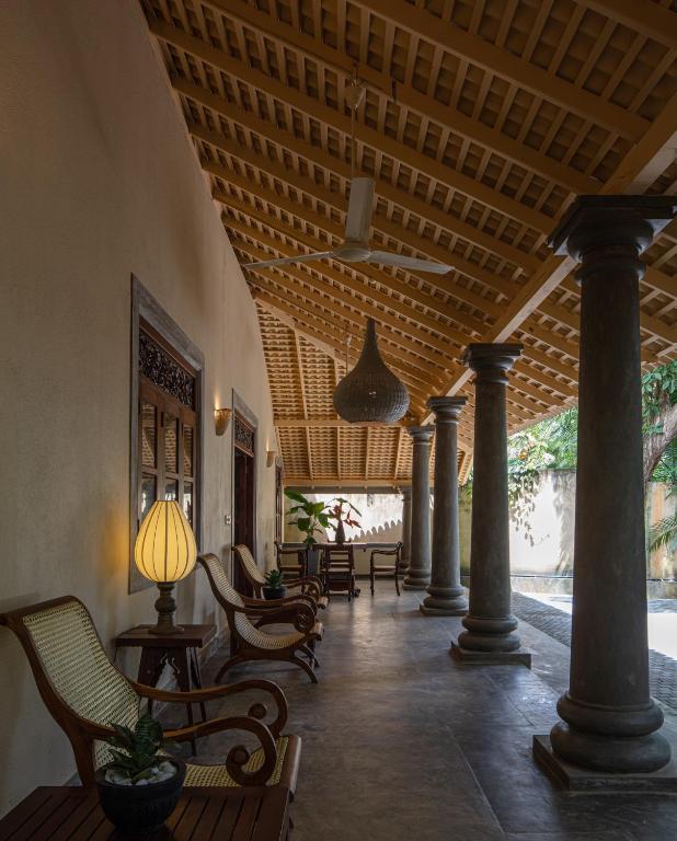a porch with chairs and a ceiling with a lamp at Green Escape Unawatuna in Unawatuna
