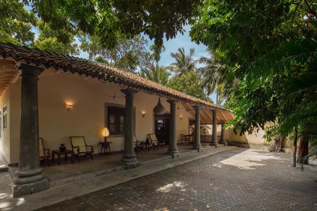 a courtyard of a house with chairs and trees at Green Escape Unawatuna in Unawatuna