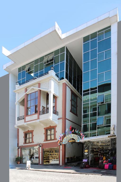 a large building with a store in front of it at Alpinn Hotel Istanbul in Istanbul
