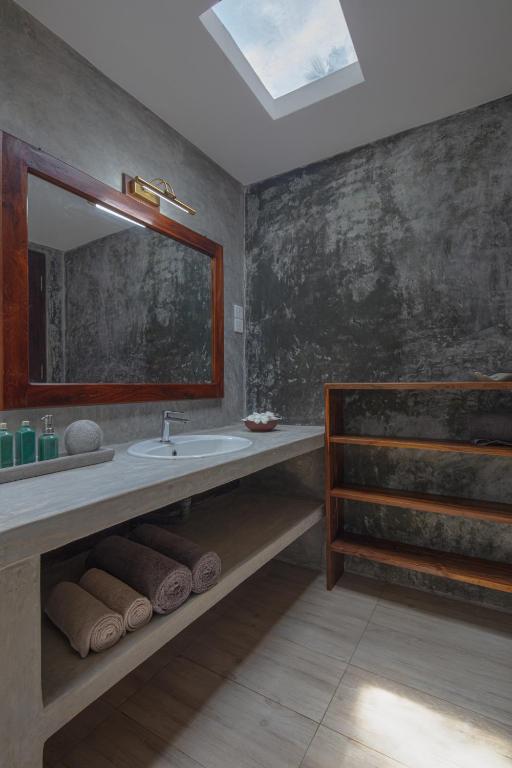 a bathroom with a sink and a mirror at Green Escape Unawatuna in Unawatuna