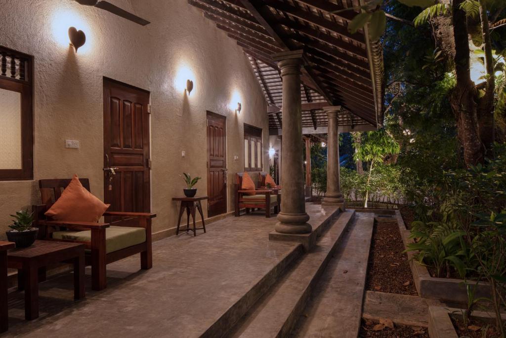 an outdoor patio with chairs and tables in a building at Green Escape Unawatuna in Unawatuna