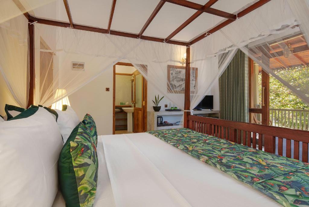 a bedroom with a white bed in a room at Green Escape Unawatuna in Unawatuna