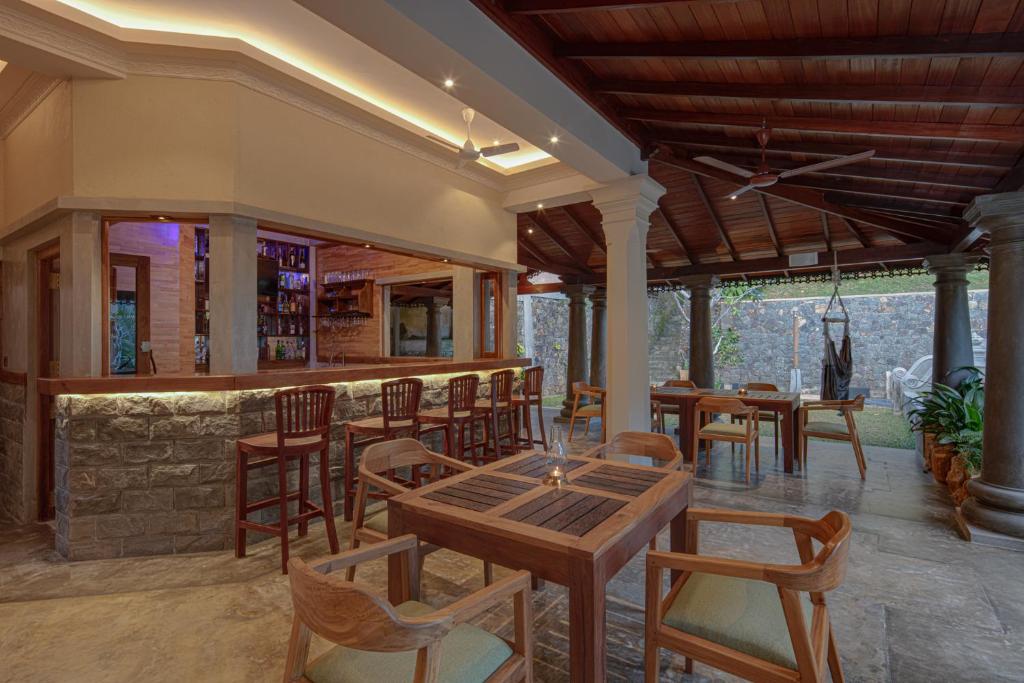 a restaurant with tables and chairs and a bar at Green Escape Unawatuna in Unawatuna