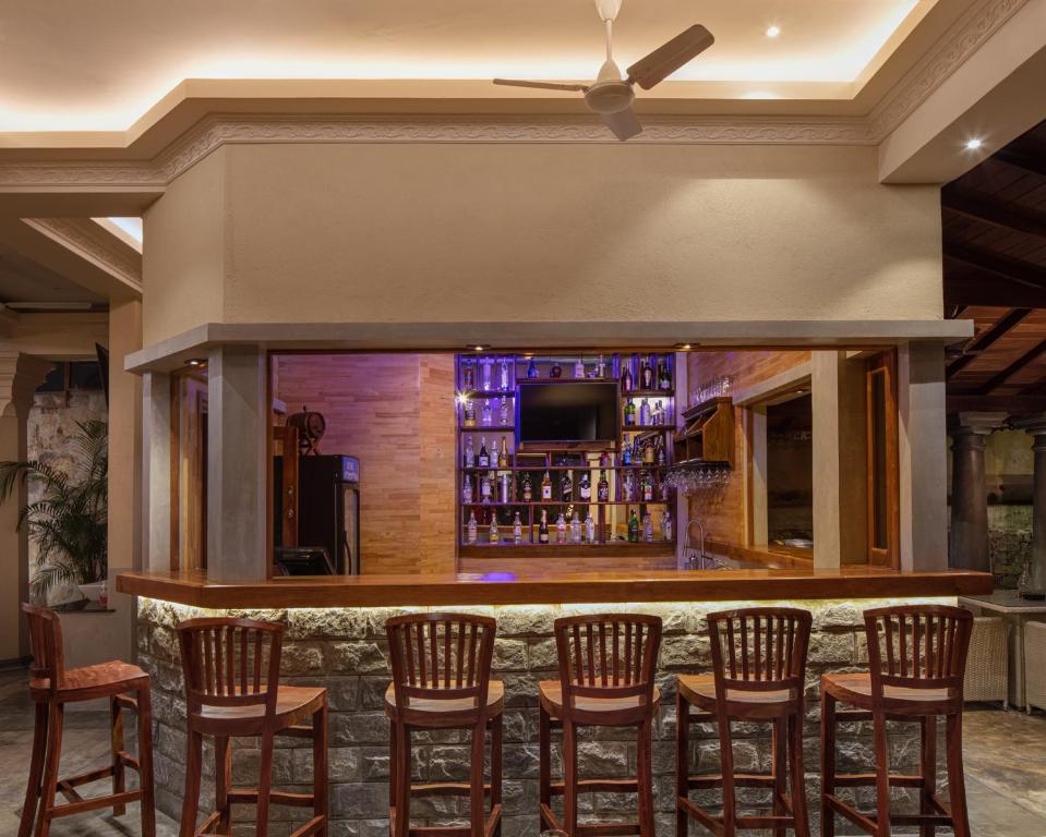 a bar in a hotel room with a bunch of chairs at Green Escape Unawatuna in Unawatuna