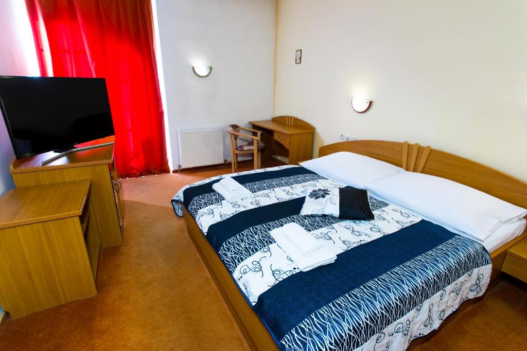 Postel nebo postele na pokoji v ubytování Hotel pod Zámkom
