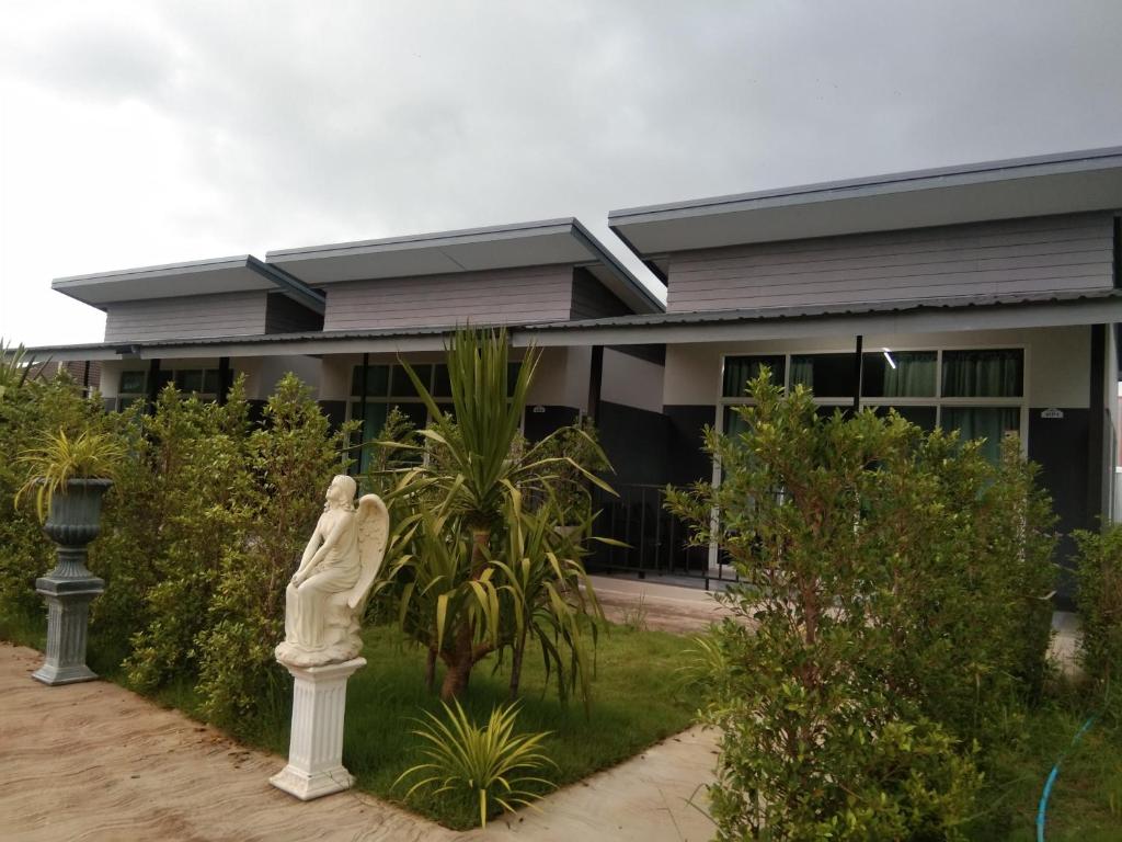 a statue of a woman in front of a building at Cessna Park Resort and Hotel in Ban Hua Na