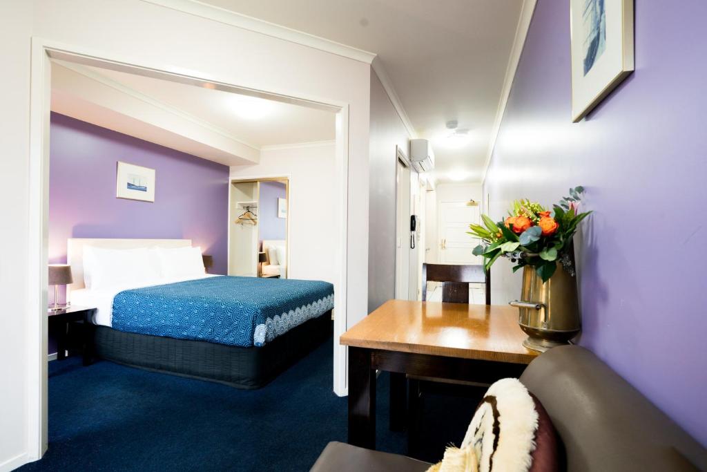 a hotel room with a bed and a couch at Arrow on Spencer in Melbourne
