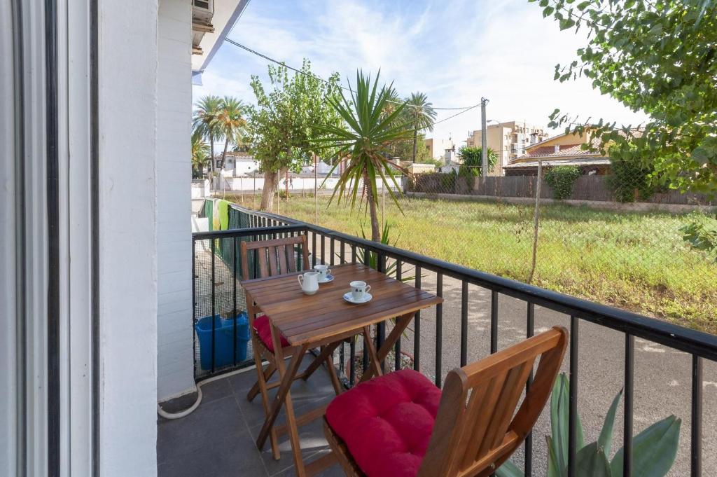 a balcony with a wooden table and two chairs at Palomas in Denia