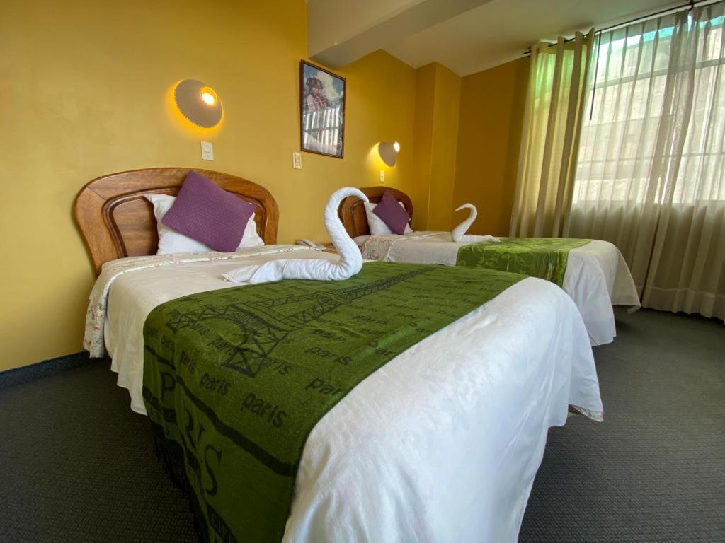 Postel nebo postele na pokoji v ubytování Hostal Oscar Inn