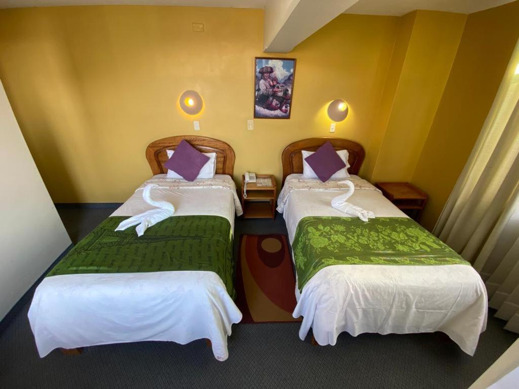 Postel nebo postele na pokoji v ubytování Hostal Oscar Inn