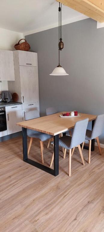 a kitchen with a wooden table and two chairs at Ferienwohnung Matzibarg in Ahrenviöl