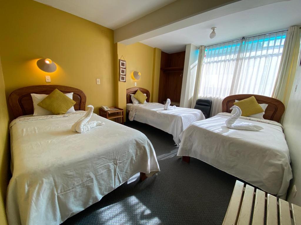 Postel nebo postele na pokoji v ubytování Hostal Oscar Inn