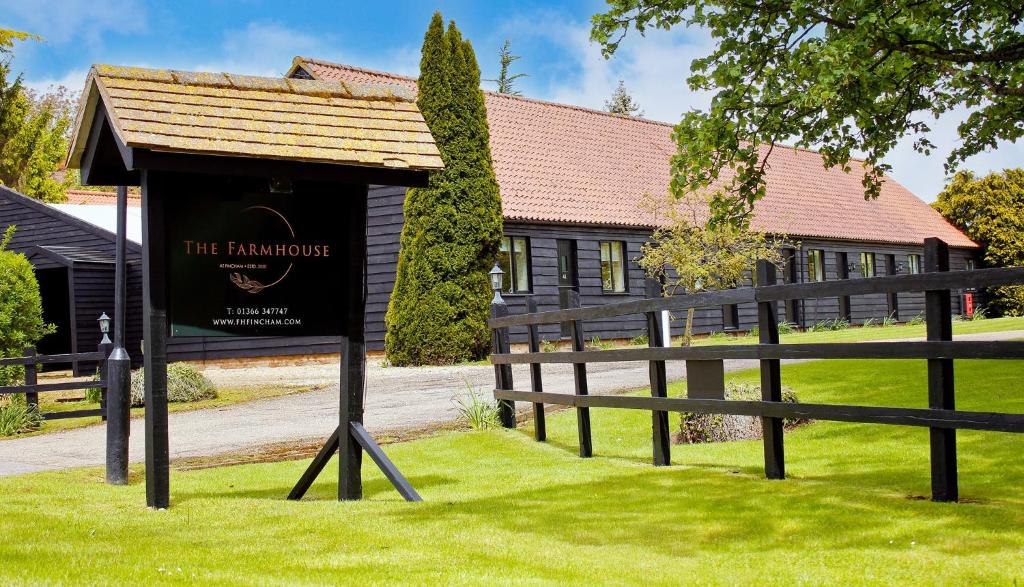 a sign in the grass in front of a building at The Farmhouse at Fincham in Fincham