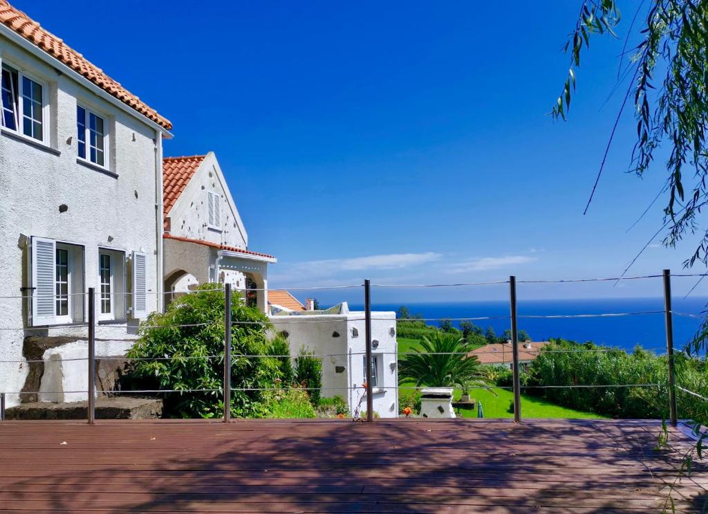 a view of the ocean from a house at Vivenda Flores - Apartment Hibisco in Lomba