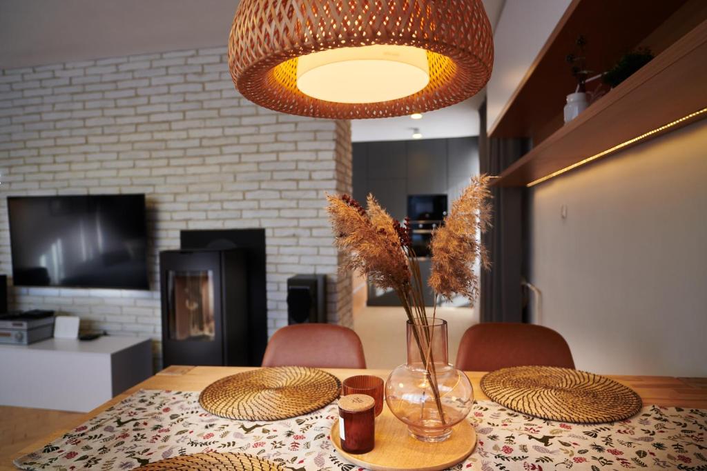 a table with hats and a vase with flowers on it at Hidden Gem of Jasna, Váš skrytý poklad v Jasnej in Liptovský Mikuláš