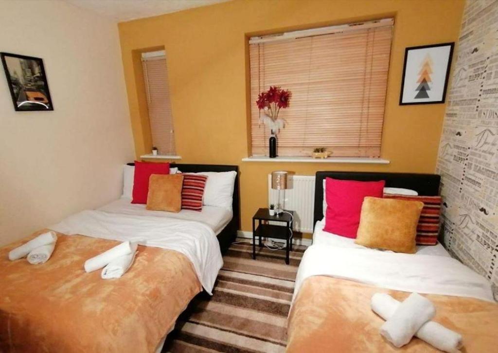 two beds sitting next to each other in a room at DaFolSuite Luxury Stay - Free WiFi with Netflix Entertainment in Tilbury