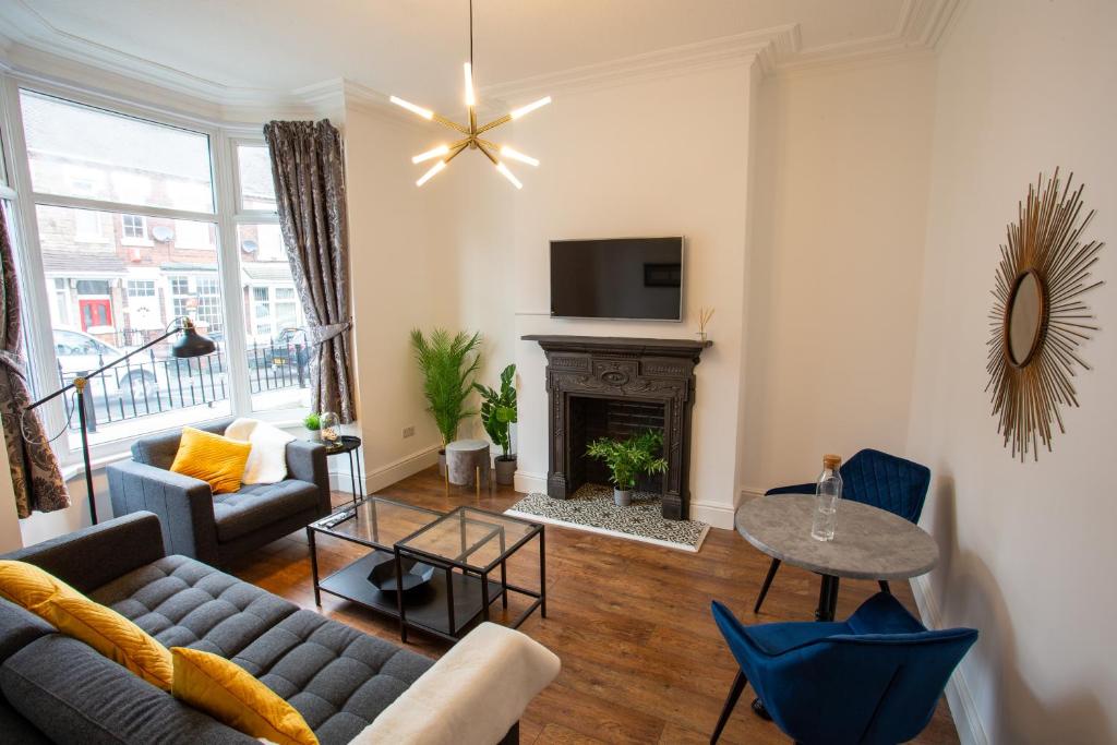 a living room with a couch and a fireplace at Birches House in Ford Green