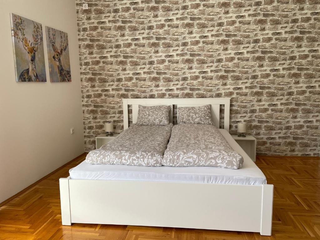 En eller flere senger på et rom på Apartman Sunny