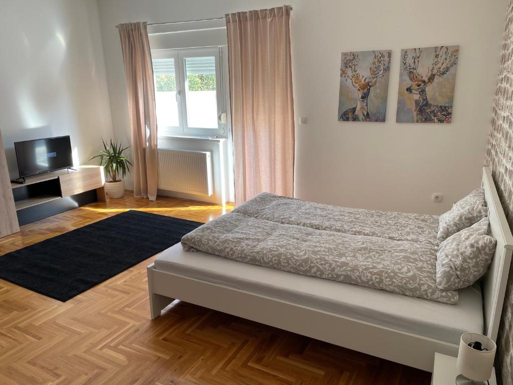 En eller flere senger på et rom på Apartman Sunny