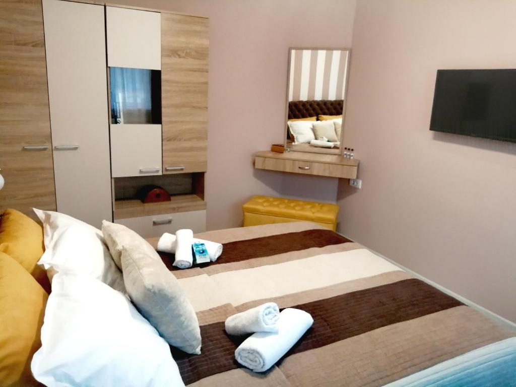 um quarto com duas camas e uma televisão na parede em ASTER apartman Bor em Bor