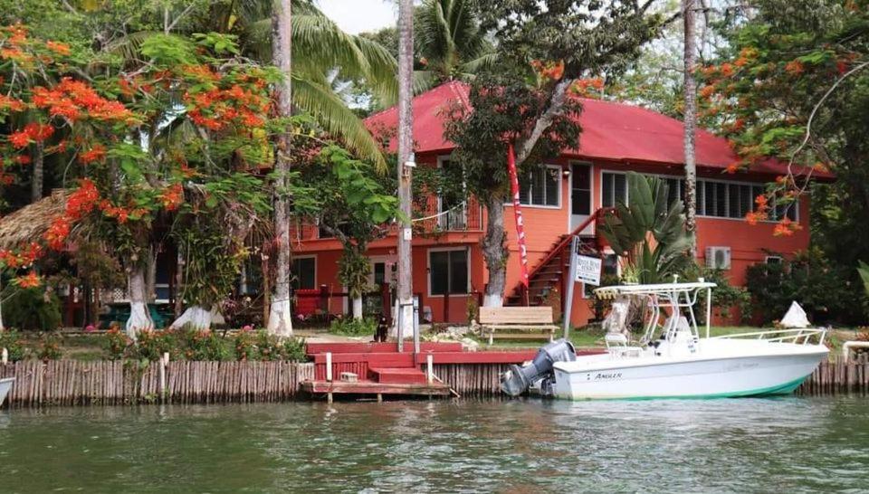 a boat parked in front of a house on the water at River Bend Resort Bze in Belize City