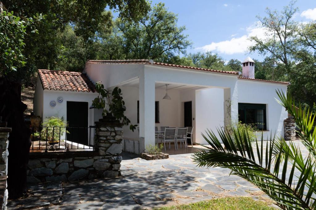 mały biały dom z werandą i patio w obiekcie Casa Rural La Gallega w mieście Aracena