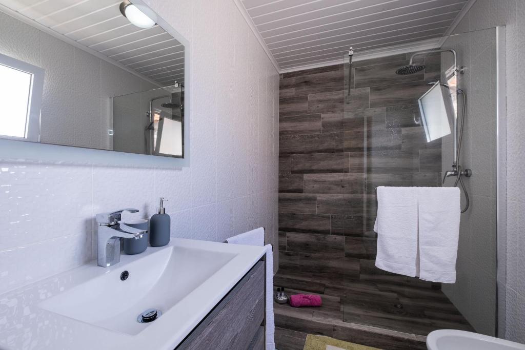 a bathroom with a sink and a toilet and a mirror at Casa Vista da Marquesa in Nordeste