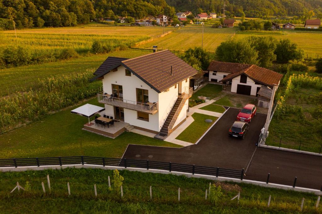 a house with a car parked in front of it at Sobe Mili Ozren in Doboj