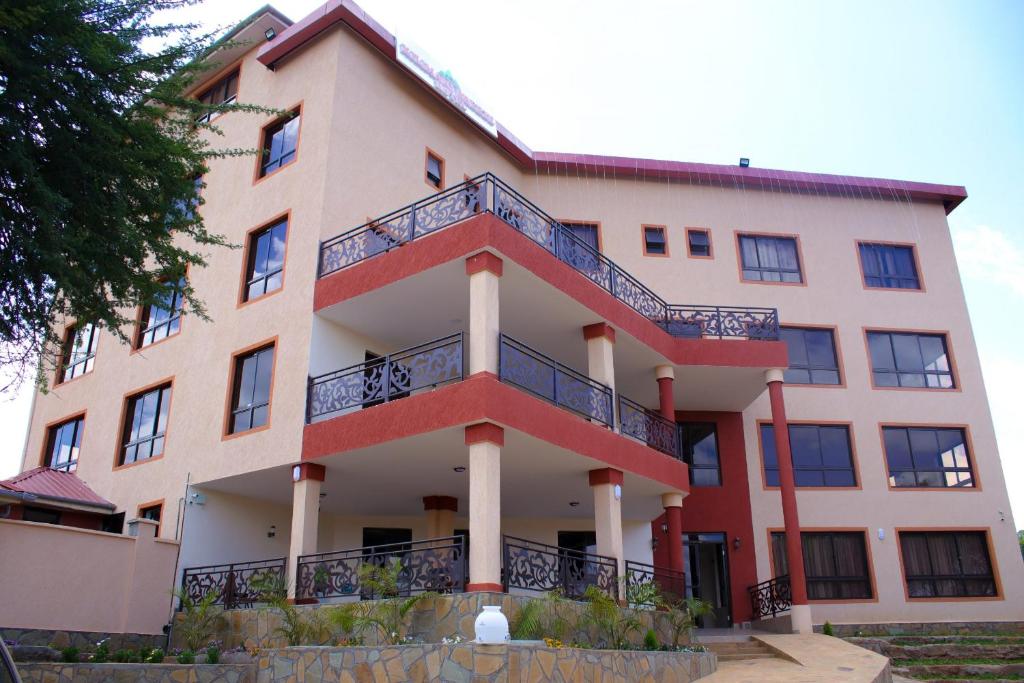 a building with a balcony on the side of it at KILIMANI BREEZE HOTEL in Wote