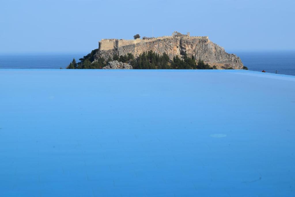 a view ofhenshenshenshens island from the top of the mountain at LINDOS GARDENS RESORT COMPLEX in Lindos