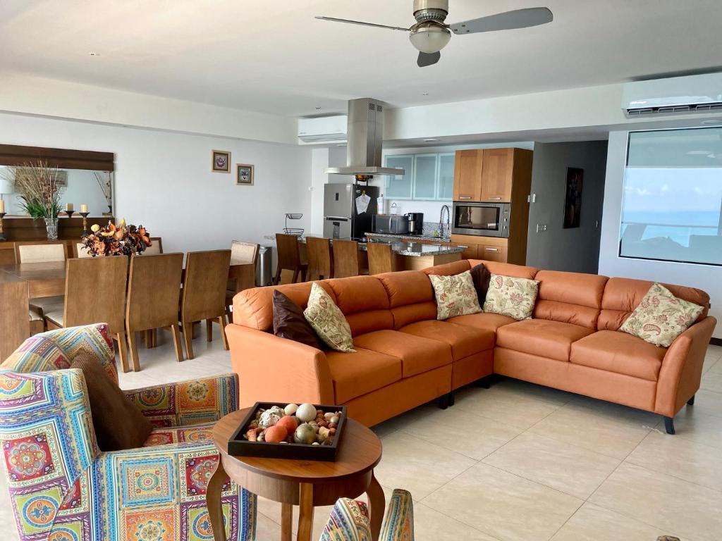 a living room with a couch and a table at Peninsula Mazatlan in Mazatlán