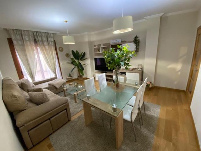 a living room with a glass table and a couch at Apartamento Centro Ciudad Pontevedra in Pontevedra