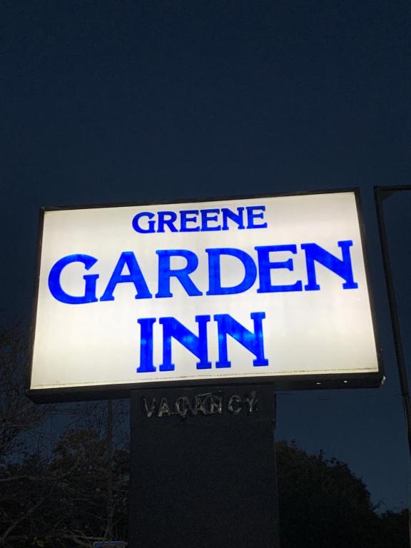 a sign for a green extreme garden inn at Green Garden Inn in Greensboro
