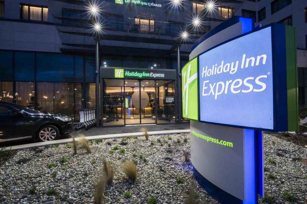 a sign for fidelityimm express in front of a building at Holiday Inn Express - Paris - CDG Airport by IHG in Roissy-en-France