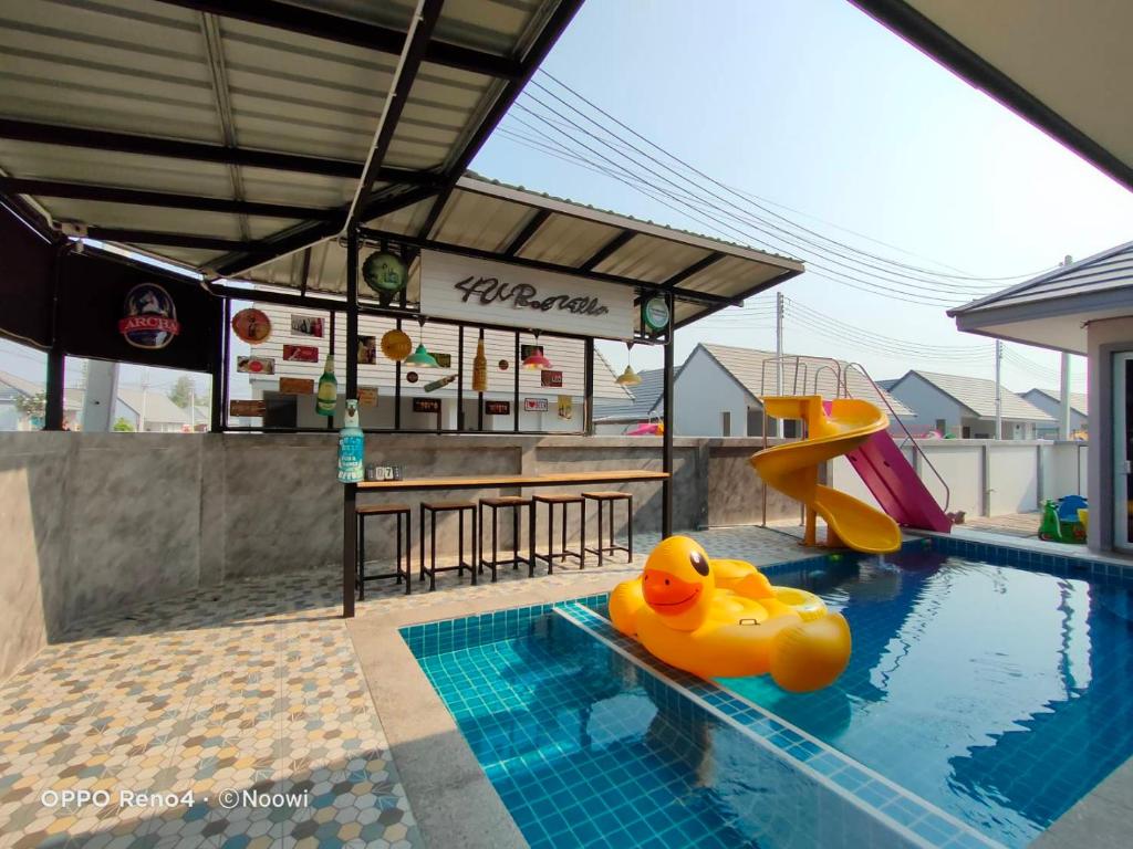 a swimming pool with a yellow rubber ducky in the water at 4U Pool Villa in Cha Am