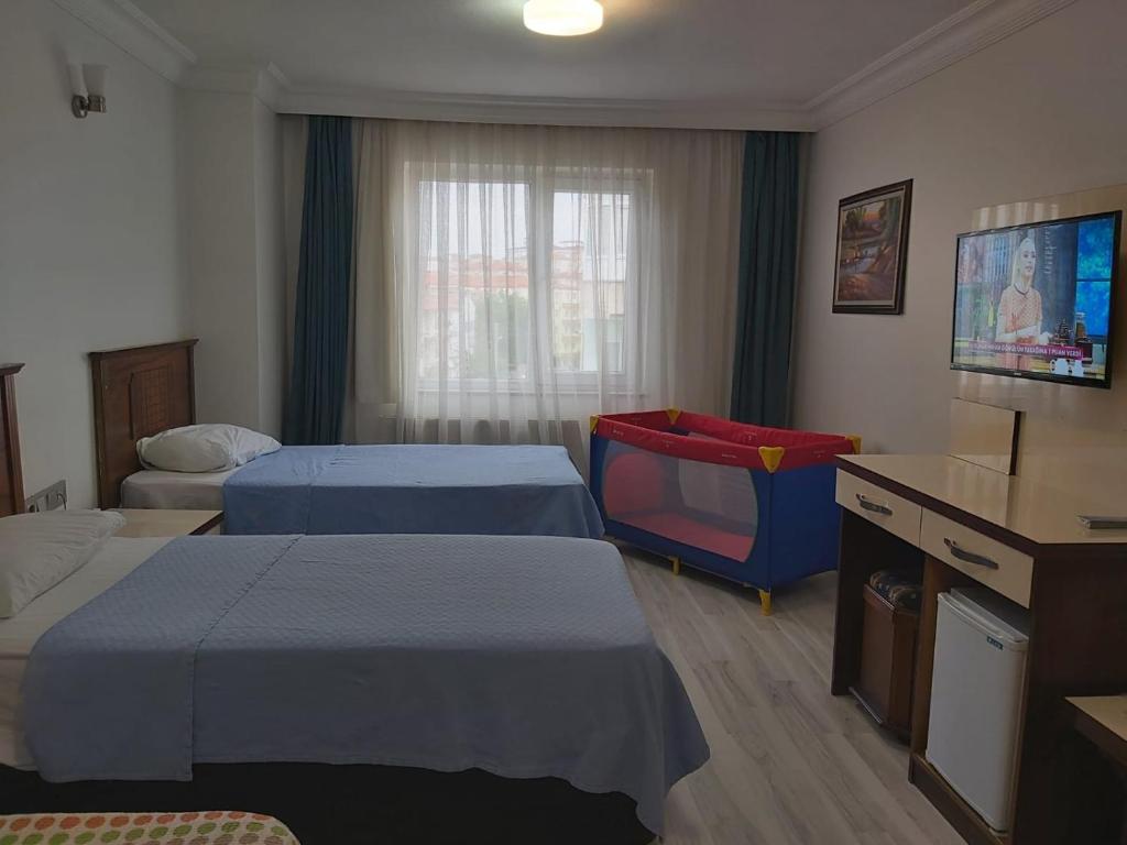 Postel nebo postele na pokoji v ubytování NAHİTA HOTEL