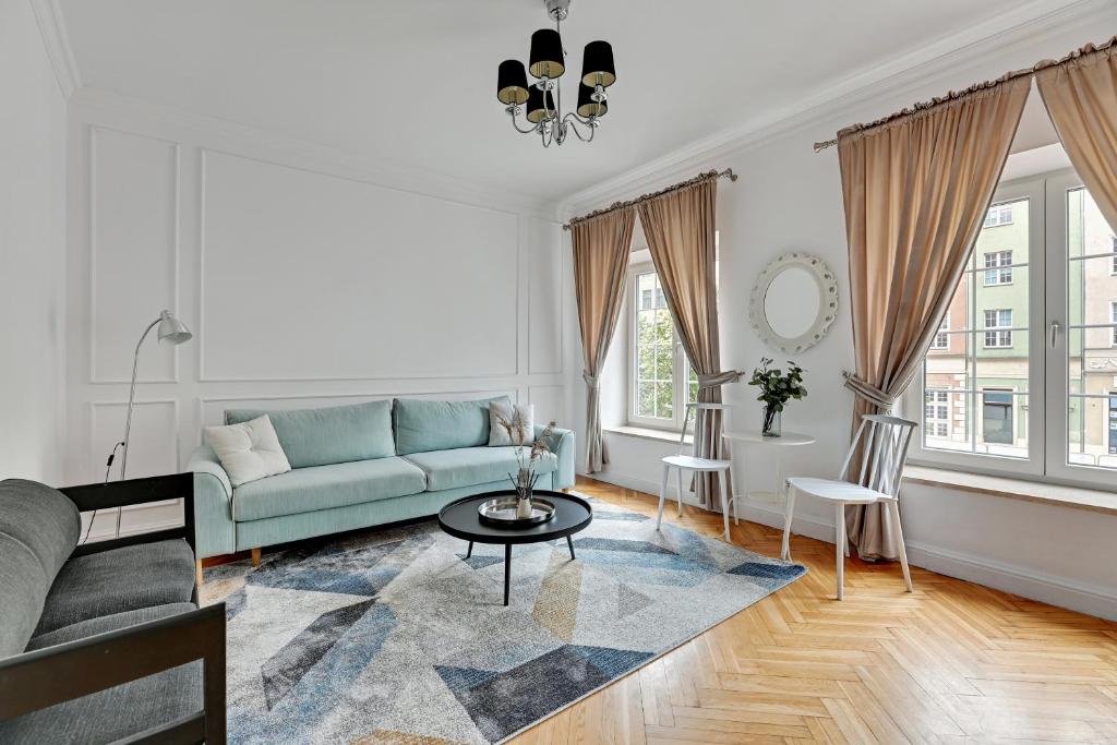 a living room with a couch and a table at Downtown Apartments Old Town View - Green Gate in Gdańsk