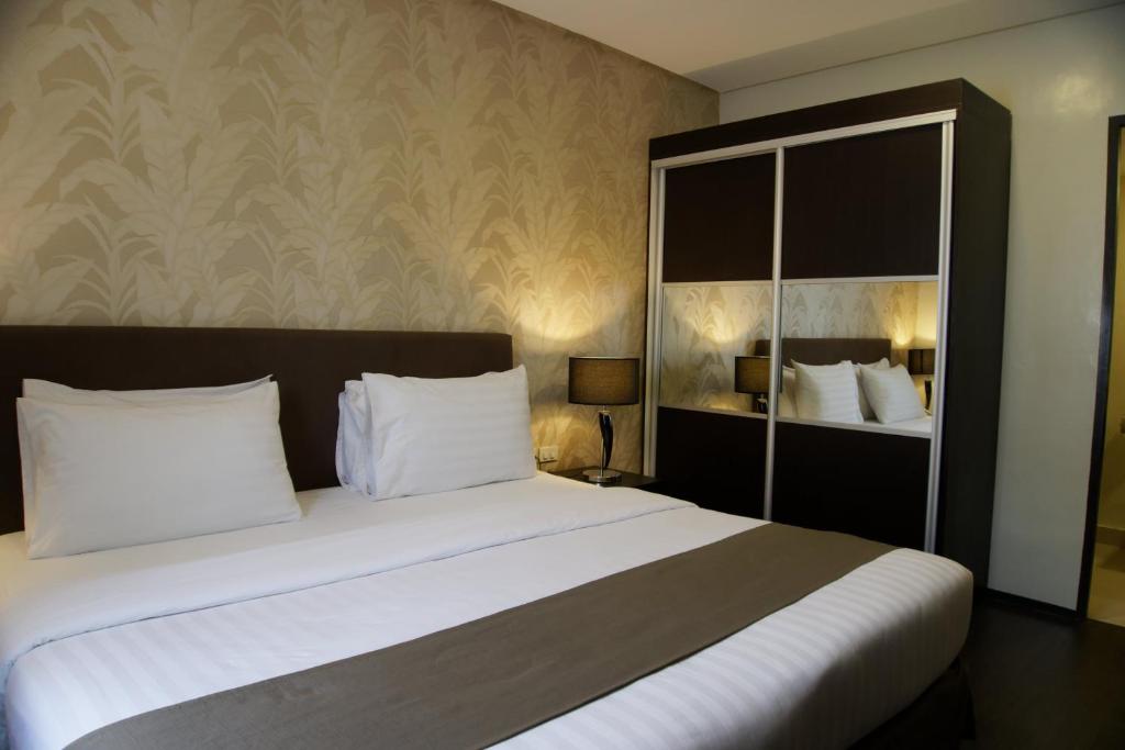 Postel nebo postele na pokoji v ubytování GT Hotel Iloilo