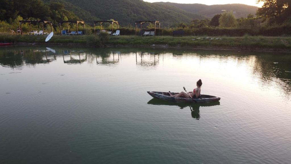 a person in a boat on a body of water at Agriturismo Podere Tegline in Radda in Chianti