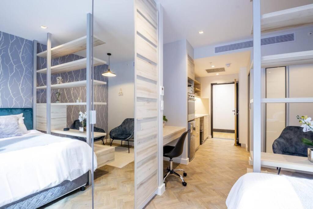a bedroom with a bed and a desk in a room at #AlimamaSpaces The Foreshore Haven in Cape Town