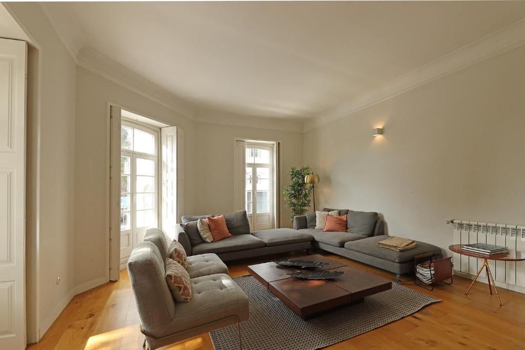 a living room with a couch and a table at FLH Seaside Luxury House in Porto in Porto