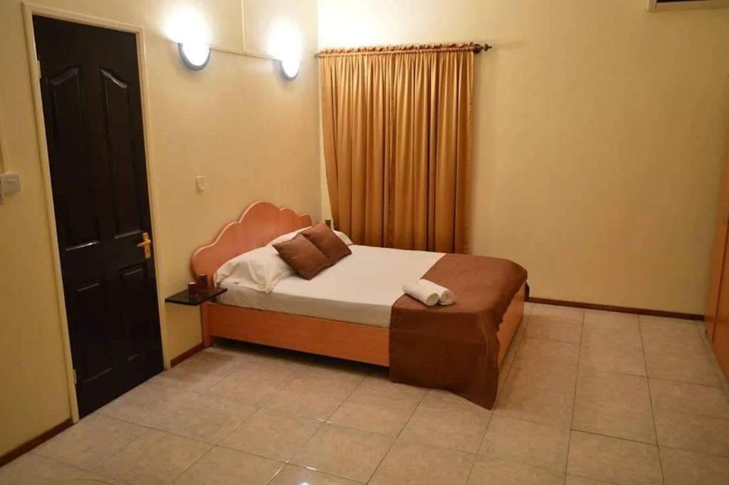 Ένα ή περισσότερα κρεβάτια σε δωμάτιο στο Bluestar Appartement 3, centre de Grand Baie