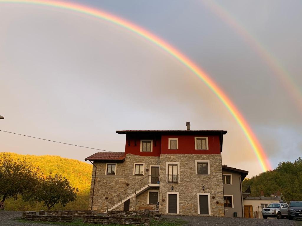 a rainbow over a house with a building at Ca’ di Matt in Mongiardino Ligure