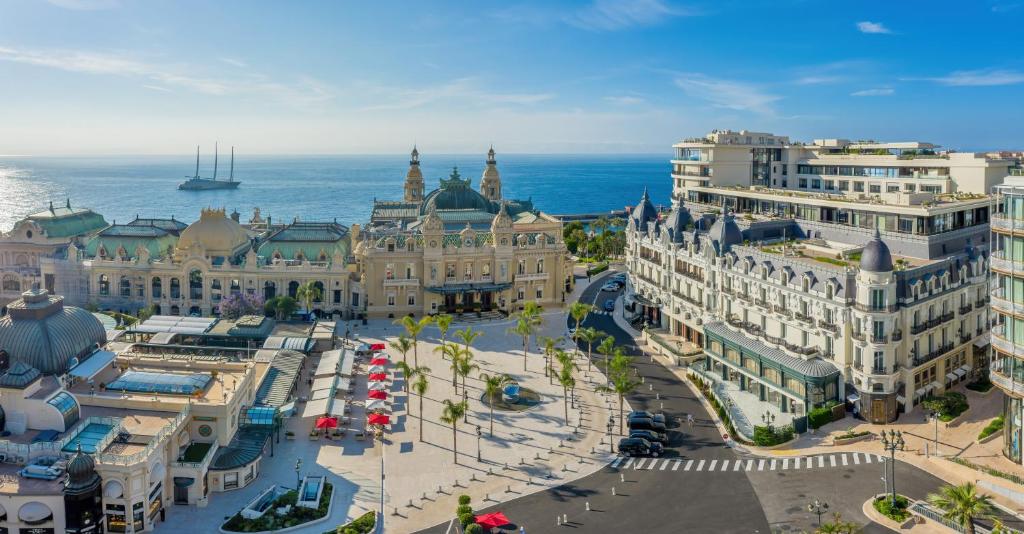 an aerial view of a city with buildings and the ocean at Hôtel de Paris Monte-Carlo in Monte Carlo